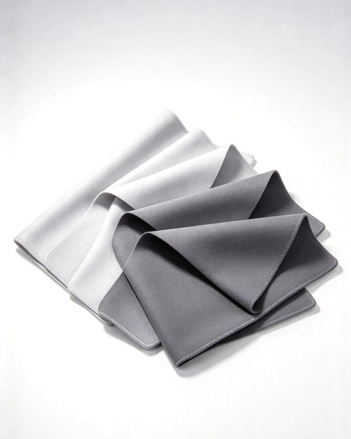 Five grey microfiber lens cloths, folded and stacked